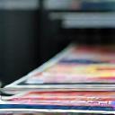 Freshly printed brochures on a digital press