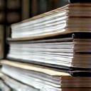 Bound documents lined up neatly